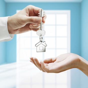 passing key against backdrop of blue room